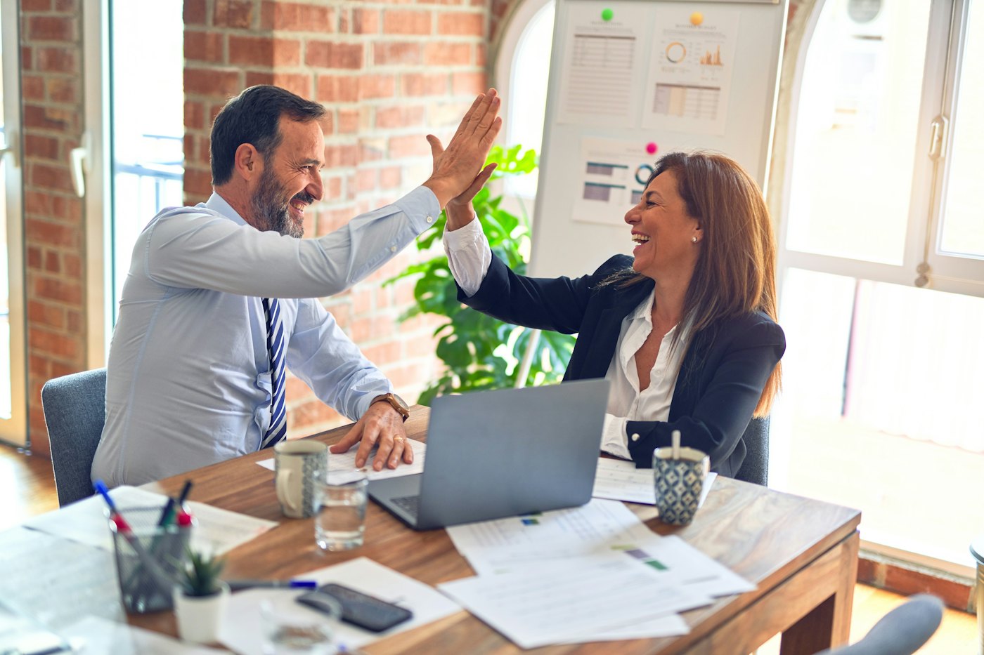 An advisor talking through a technology plan with a business owner at a table